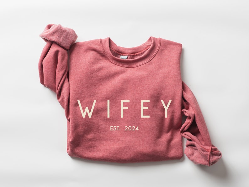 May include: A maroon sweatshirt with the text "WIFEY EST. 2024" printed in white.