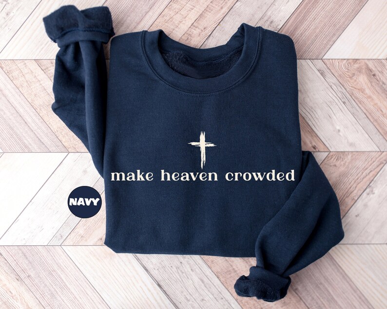 May include: Navy blue sweatshirt with a white cross and the text "make heaven crowded".