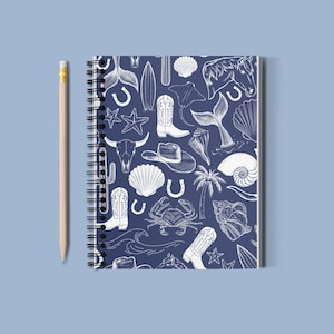 May include: A blue spiral notebook with a white pattern of various nautical and western themed illustrations, including seashells, horseshoes, palm trees, cowboy boots, and starfish.
