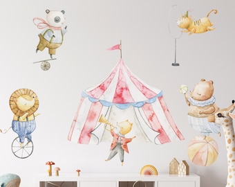 May include: A set of colorful circus animal wall decals featuring a red and white striped tent, a panda balancing on a ball, a lion riding a unicycle, a pig playing a trumpet, a cat hanging from a hoop, and a bear balancing on a ball.
