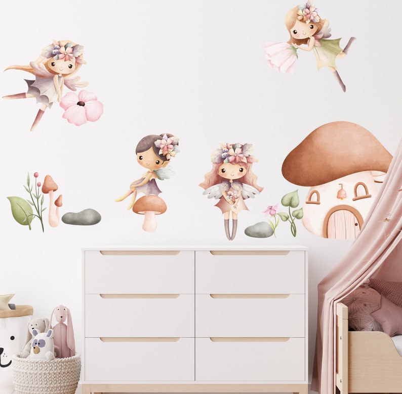 May include: A set of five wall decals featuring fairies with floral crowns and wings, mushrooms, and a mushroom house. The decals are in shades of brown, pink, and green.