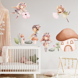May include: A set of four watercolor fairy wall decals with mushroom houses, flowers, and leaves. The fairies are wearing floral crowns and have wings. The decals are perfect for a nursery or child's room.