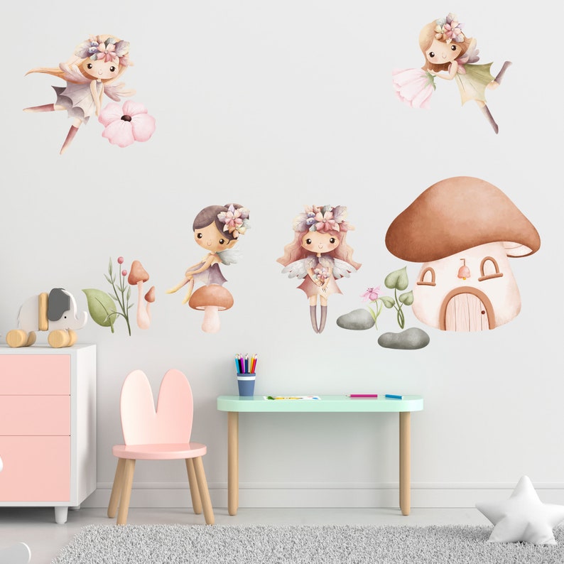 May include: Five watercolor fairy stickers with floral crowns and wings. The fairies are holding flowers and are surrounded by mushrooms, flowers, and leaves. There is also a brown mushroom house with a white door.