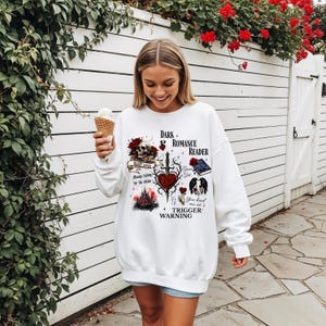 Minimalistisch “Dark Romance Reader” tekstdesign op hoodie, sweatshirt of T-shirt voor romance readers. Perfect voor fans van de enemies-to-lovers trope en bookish fashion. Zacht, comfortabel en ideaal om te dragen tijdens het lezen. Stijlvol cadeau voor boekenliefhebbers.