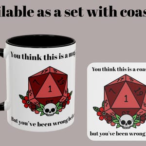 May include: A white mug with a black handle and rim, and a matching coaster. Both feature a red die graphic with the text "You think this is a mug/coaster... but you've been wrong before."