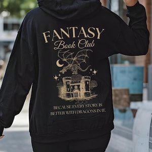 May include: Black hooded sweatshirt with a gold graphic of a dragon flying over a castle. The text "Fantasy Book Club" is above the graphic and the text "Because every story is better with dragons in it." is below the graphic.