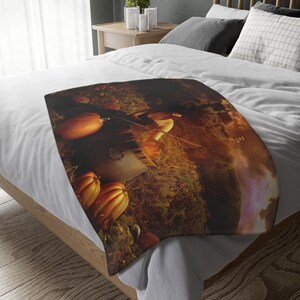May include: A blanket with a fall-themed design featuring pumpkins and mushrooms. The blanket is draped over a bed with white sheets and pillows. The color palette includes shades of orange, brown, and green.