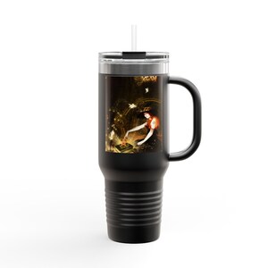 May include: Black travel mug with a handle and a straw. The mug features a fantasy art print of a woman in a red dress, surrounded by stars and light. The mug is designed to keep beverages hot or cold.