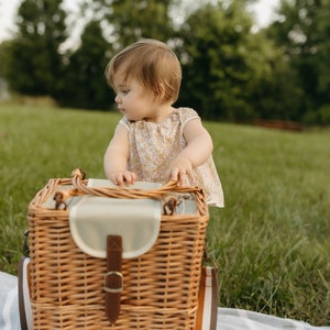 Babies can also use this wicker picnic basket to cruise after eating their lunch.