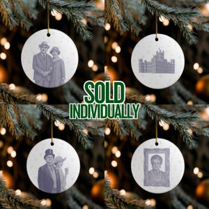 May include: Four round, white ceramic ornaments hanging from gold strings, each with a different vintage-style image. The images include a couple, a building, a couple, and a portrait. The text "SOLD INDIVIDUALLY" is in green.