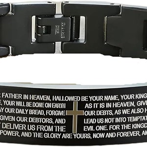 May include: Black stainless steel bracelet with a gold trim and a black plate engraved with the Lord's Prayer.
