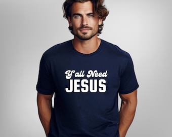 May include: A navy blue t-shirt with white text that reads "Y'all Need JESUS" in a retro font.