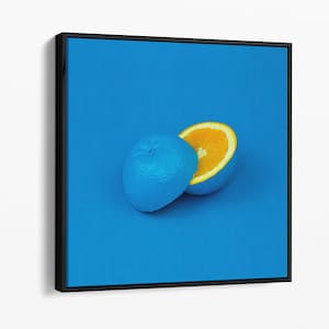 May include: A blue orange and a half of an orange on a blue background.