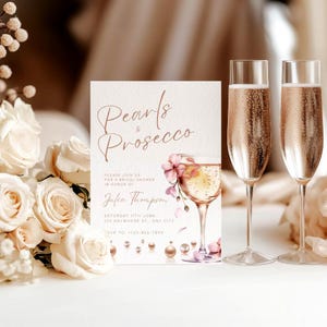May include: A bridal shower invitation with a watercolor illustration of pink flowers and a glass of champagne. The text reads "Pearls & Prosecco" and includes the bride's name, date, and RSVP information.