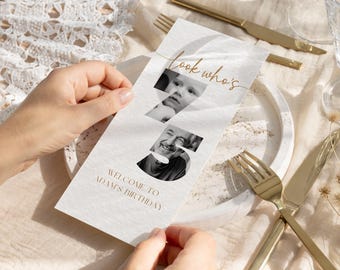 May include: A white birthday invitation with the text "look who's 5" and "Welcome to Adam's Birthday". The number 5 is cut out to reveal two black and white photos. Gold cutlery and a plate are in the background.