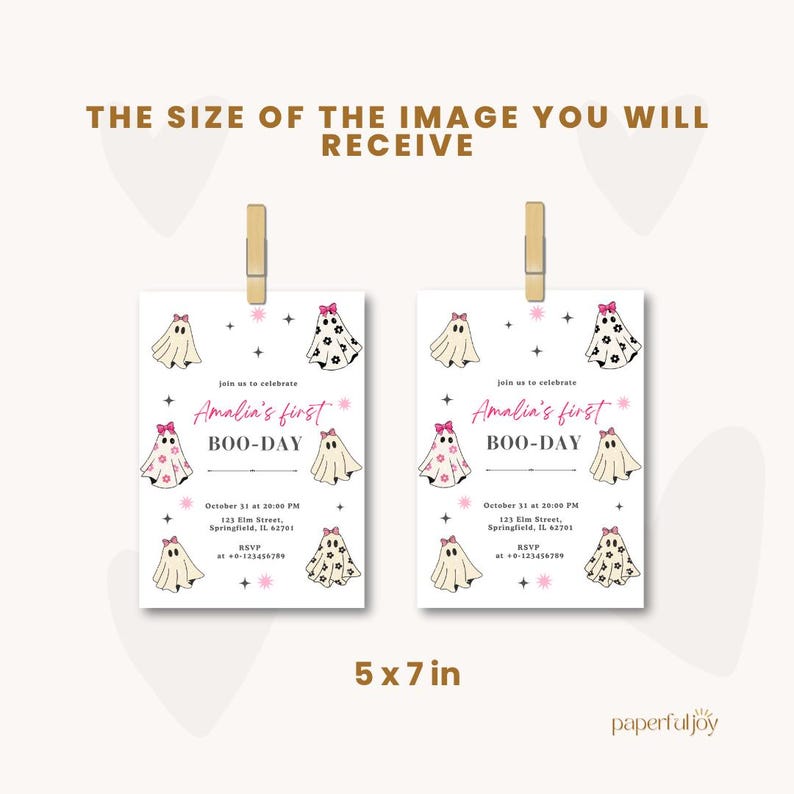 May include: Two Halloween-themed invitations, each 5 x 7 inches, are displayed. The invitations feature ghost illustrations with pink bows and the text "Amalia's first BOO-DAY". The invitations are held by wooden clips.