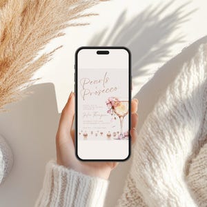 May include: A digital invitation for a bridal shower with the text "Pearls & Prosecco" in rose gold lettering. The invitation features a watercolor illustration of a champagne flute with pink flowers and gold pearls.