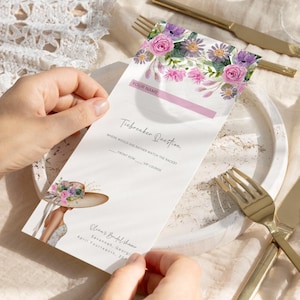 May include: A white card with a floral design at the top. The card has a pink stripe and the text "Tiebreaker Question" in black. The text "Where would she rather watch the races?" is in black. The text "Front Row" and "VIP Lounge" are in black. The card also has the text "Olina's Bridal Shower" in black. The text "Savannah, Georgia" is in black. The text "April Fourteenth, 202" is in black. The card has a watercolor illustration of a woman wearing a hat with flowers on it.