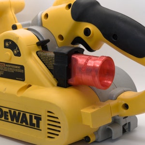 May include: A yellow and black DeWalt belt sander with a red dust collection port. The sander has a black handle and a warning label.
