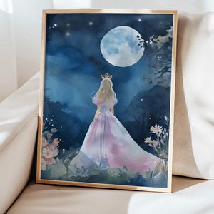 May include: A framed watercolor print of a princess in a flowing pink and purple gown, facing away from the viewer, with a golden crown. The background features a large moon, stars, and a dark blue night sky. Flowers and foliage are in the foreground.