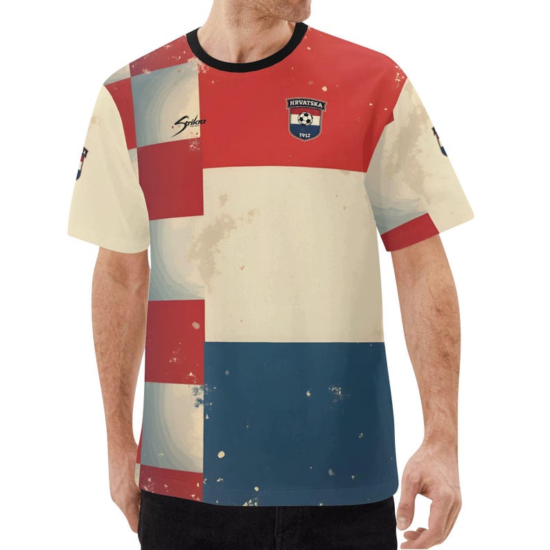 May include: A short-sleeved t-shirt with a vintage design. The shirt features a color block pattern in cream, red, and blue. The upper chest has a Croatian soccer emblem. The word "Spiko" is printed on the left side.