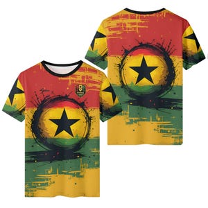 May include: A short-sleeved t-shirt featuring the Ghana flag design. The shirt has a black star on a yellow circle, set against a red, yellow, and green background. The Ghana emblem is on the front.