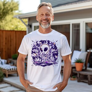 Alien t-shirt,Gun-wielding alien design,Sci-fi clothing,Space war theme,Unique shirt design,Alien conflict apparel,Action-themed attire