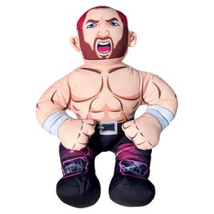 May include: A soft toy of a muscular man with red hair and a beard, wearing black trousers with a pink and purple design, and black boots. The doll has a stern expression and is wearing a silver belt and wristbands.
