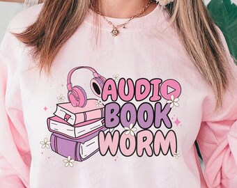 May include: Pink sweatshirt with a graphic design of headphones, books, and the text "AUDIO BOOK WORM".