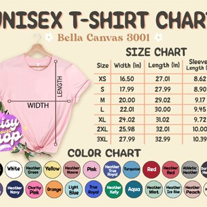 May include: A pink t-shirt on a hanger, with a size and colour chart. The chart lists measurements in inches for sizes XS to 3XL. The colour chart shows various colours, including black, white, and red.
