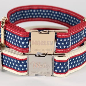 May include: Two red, white, and blue dog collars with silver buckles. The top collar has the name "MARLEY" and phone number "(000) 111-2345" engraved on the buckle. The bottom collar has the name "Molly" and phone number "(000) 111-2345" engraved on the buckle.