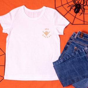 Ladies Minimal Halloween Skeleton Logo T-Shirt (White & Orange)