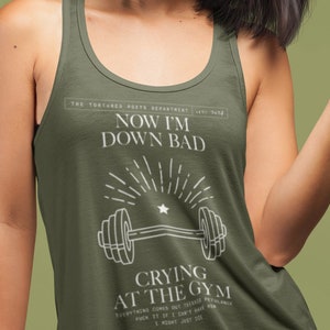 girl woman wearing a taylor swift lyric womens tank top featuring down bad from the tortured poets department