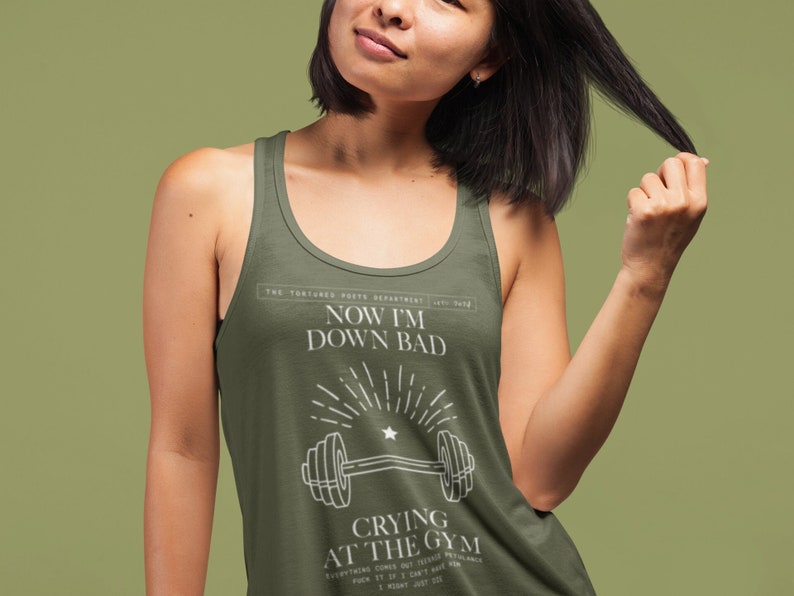 girl woman wearing a taylor swift lyric womens tank top featuring down bad from the tortured poets department