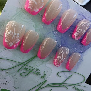 Pink french tip hibiscus Hawaiian flower press on nails with a sparkly base.