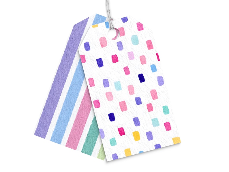 May include: Two gift tags with a watercolor design. One tag features vertical stripes in pastel colors, while the other has a white background with colorful rectangular shapes. Both tags are connected with a white string.