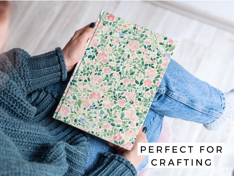 May include: A notebook with a floral pattern featuring pink and green flowers on a white background. The text "PERFECT FOR CRAFTING" is printed on the bottom of the image.