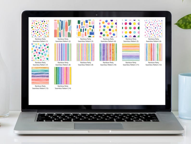 May include: A laptop screen displays a collection of colorful digital seamless patterns labeled "Rainbow Party." The patterns feature various designs, including polka dots, brushstrokes, and stripes in a vibrant rainbow palette. The laptop is on a white desk.
