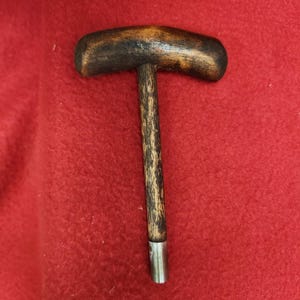Ball starter with wooden handle.