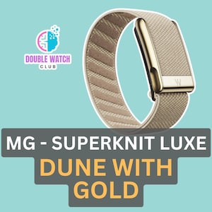 May include: A beige Superknit Luxe watch band with gold accents. The band features a woven texture and a gold clasp. The text "MG - SUPERKNIT LUXE DUNE WITH GOLD" is displayed below the watch band.