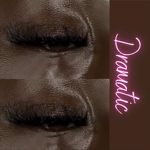 May include: Close-up of two eyes with dramatic false eyelashes. The eyelashes are long and thick, giving the eyes a dramatic look. The text "Dramatic" is written in pink neon letters on the right side of the image.
