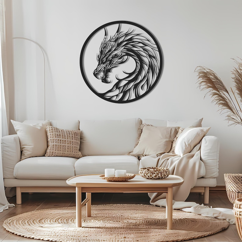 May include: A black metal dragon wall art piece. The dragon is depicted in profile within a circular frame. The artwork features intricate details, showcasing the dragon's head, horns, and flowing mane. The piece is mounted on a white wall above a cream-colored sofa.