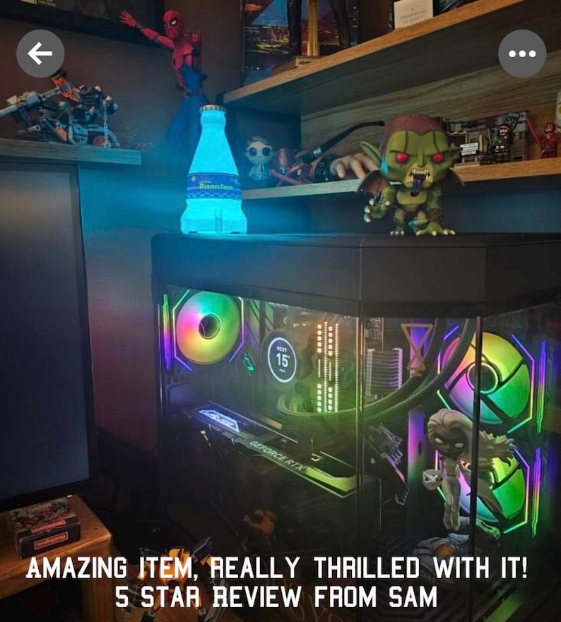 May include: A black computer case with a clear side panel, showcasing colorful RGB fans and a graphics card. The case is lit with blue and green lights. The text "GEFORCE RTX" is visible on the graphics card.