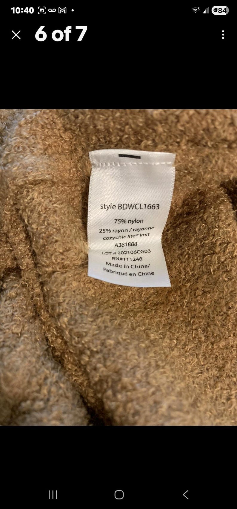 May include: A close-up of a label with the text "style BDWCL1663", "75% nylon", and "25% rayon/rayonne cozychic lite knit". The label also includes the numbers "A381888", "LOT #202106CG03", and "RN#111248".