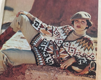May include: A hardcover book titled make it yourself The Complete Step-by-Step Library of Needlework and Crafts. The cover features a person wearing a patterned knit cardigan, a tan cap, and light-colored trousers, reclining on a rocky surface.