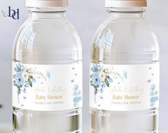 May include: Two clear plastic water bottles with blue and white floral labels. The labels have the text "Amber & Anthony Baby Shower Thanks for coming!"