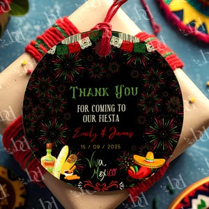 May include: A round black gift tag with a red string, featuring a festive design. The tag includes the text "Thank You For Coming To Our Fiesta" in green, along with a date and the words "Viva Mexico". The design incorporates fireworks, a sombrero, and other Mexican-themed illustrations.
