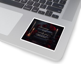 May include: A sticker with a dark background featuring a stack of books, red roses, and lit candles. The text on the sticker reads "Swooning over morally grey characters".