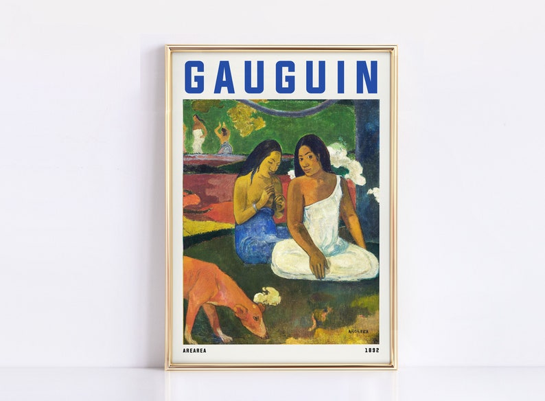 May include: Framed art print of a Gauguin painting featuring two women in white and blue garments, with a red dog in the foreground. The word "GAUGUIN" is in blue block letters at the top.
