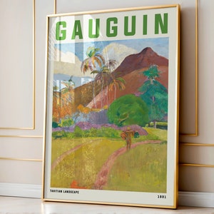 May include: Framed art print of a Gauguin painting, featuring a vibrant Tahitian landscape. The artwork displays a path leading through a field, with palm trees, mountains, and a figure carrying a load. The text "GAUGUIN" and "TAHITIAN LANDSCAPE 1891" are visible.
